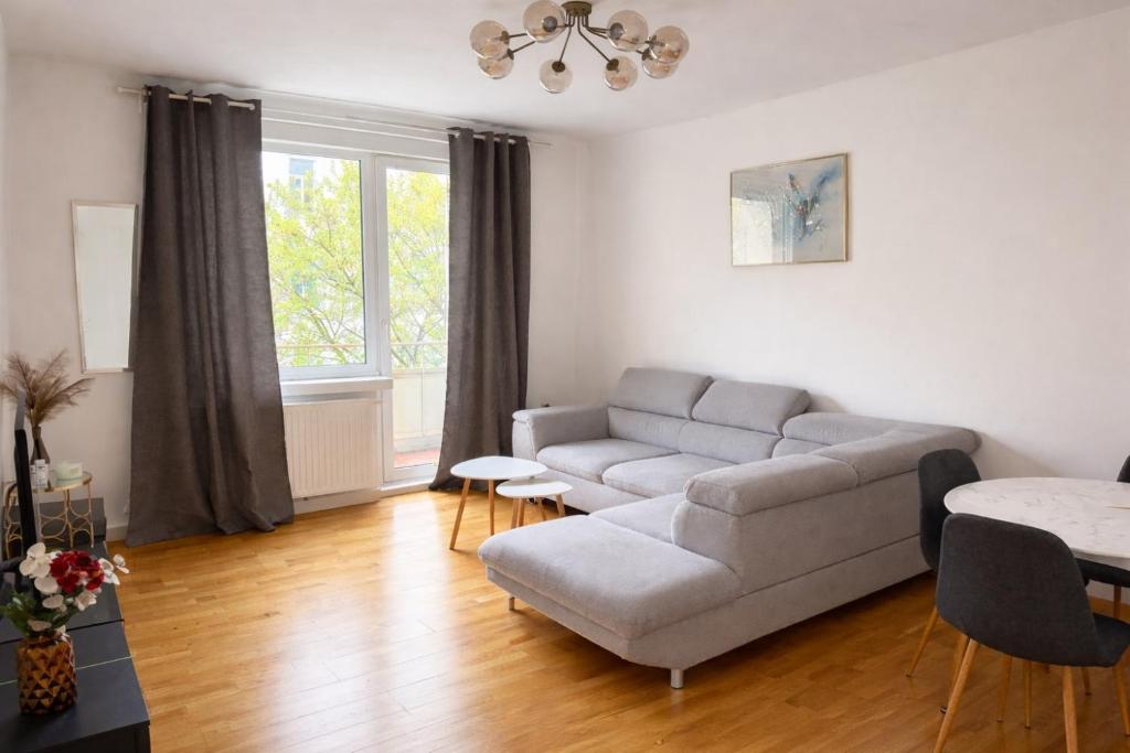 a living room with a couch and a table at Schöne Wohnung mit Balkon in Vienna