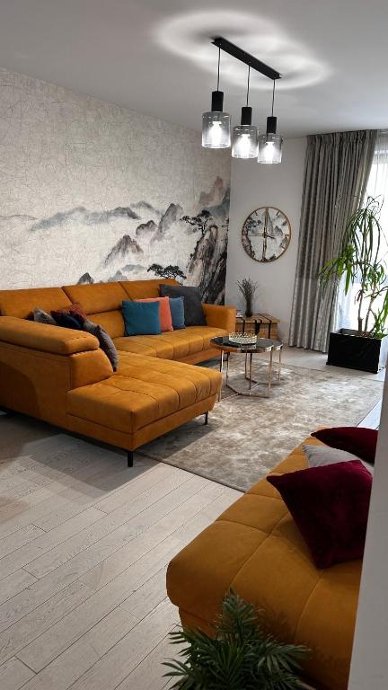 a living room with two couches and a table at Herastrau Prestige Apartment WIN in Bucharest