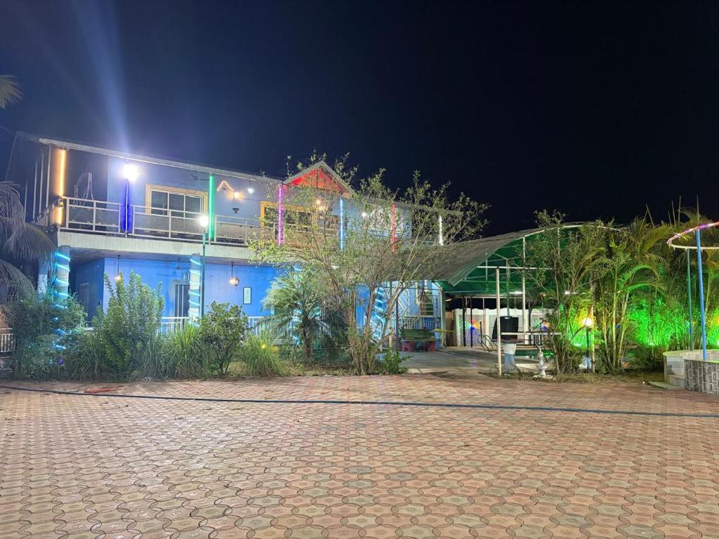 a house at night with a brick road in front of it at Bhogwal farm house in Karjat