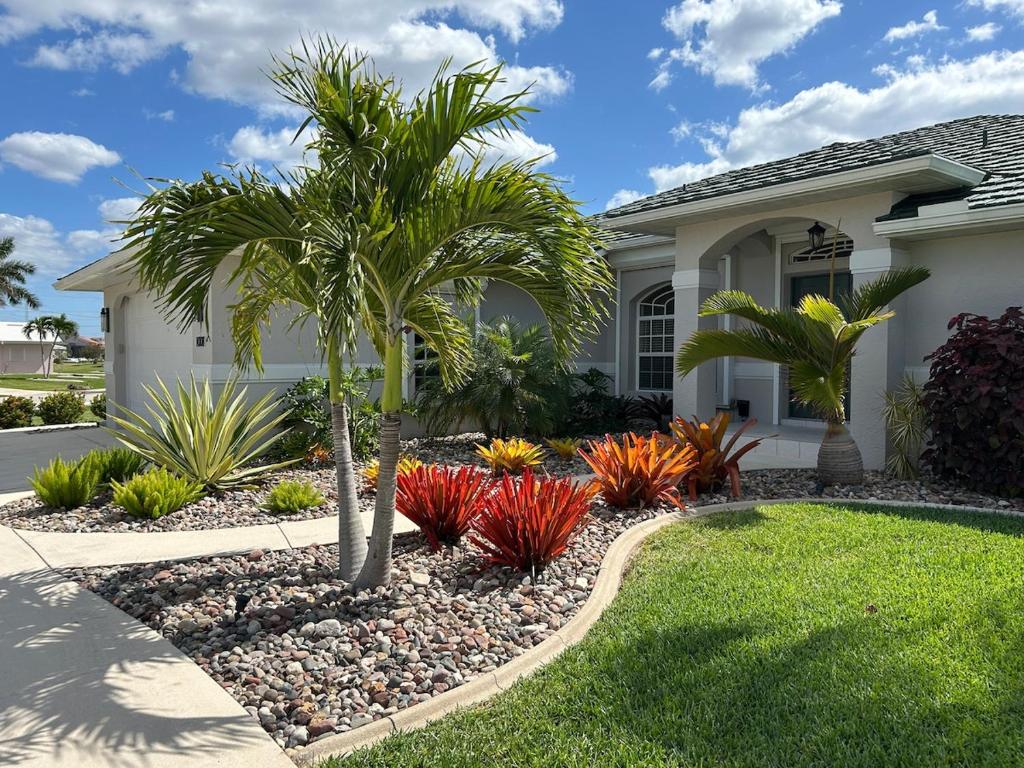 a house with palm trees in the front yard at Salted Sunset at Punta Gorda Isles in Punta Gorda