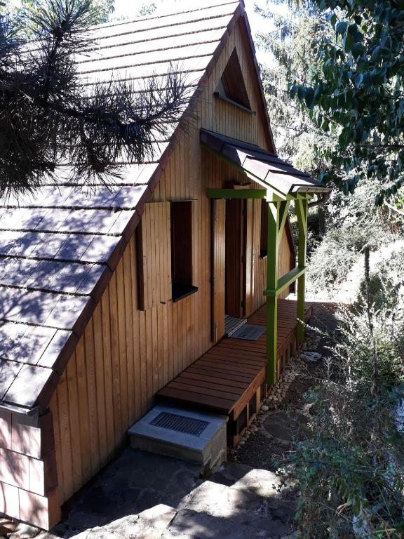 a wooden building with a porch and a roof at Chalet Z en Alsace in Barr