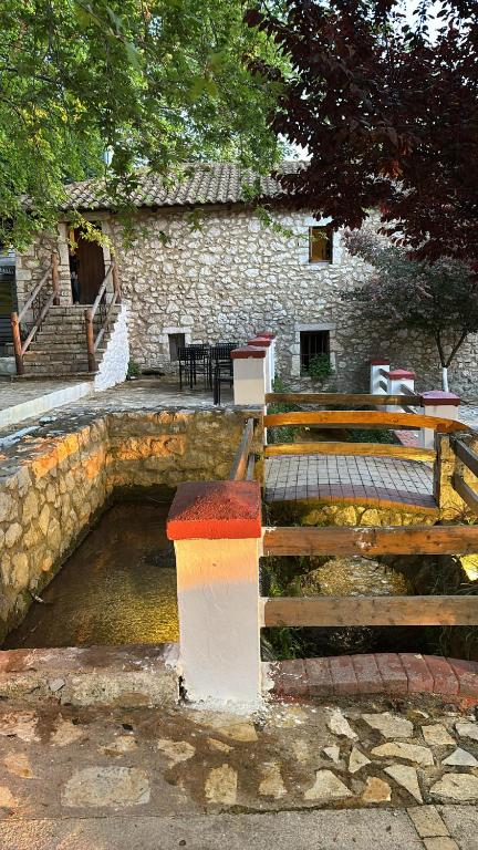 a bench sitting in front of a stone building at The Millers Room at Neromilos Watermill in Monastirákion