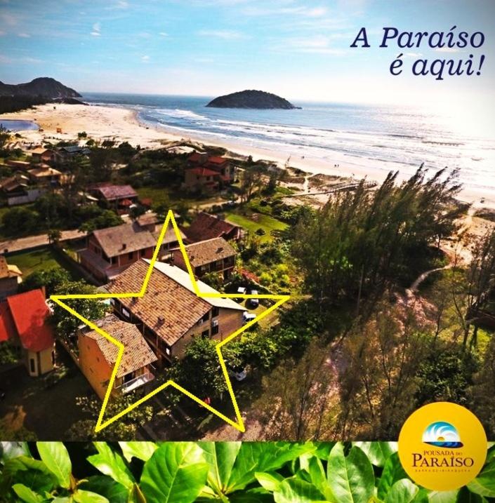 a view of a beach with a house and the ocean at Pousada do Paraiso in Barra de Ibiraquera