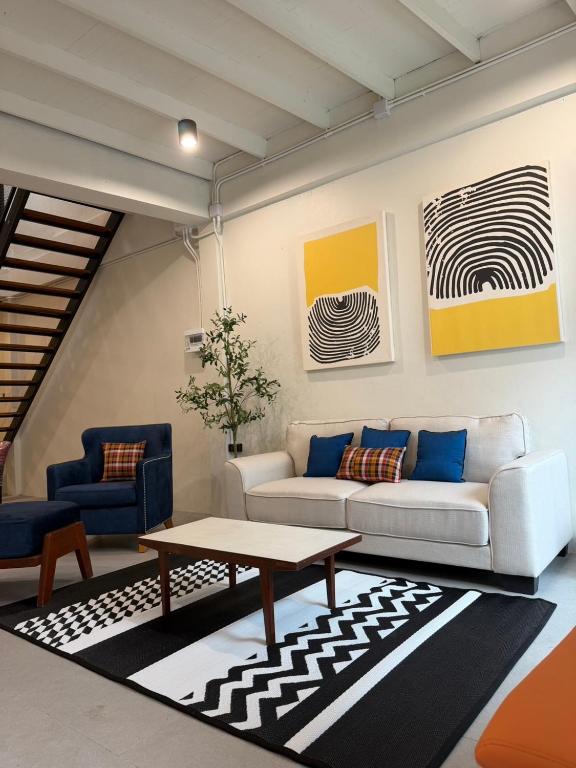 a living room with a couch and a table at Casa Yu in Hat Yai