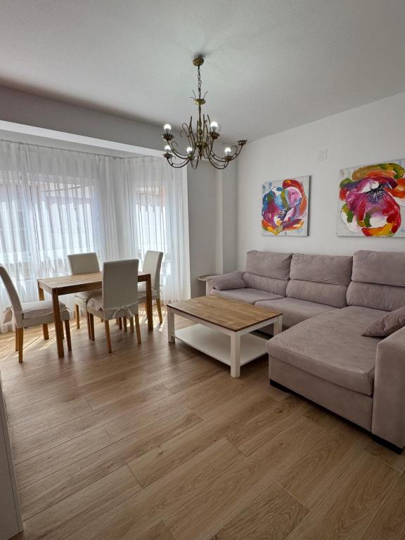 a living room with a couch and a table at Dalia Somhome in Peniscola