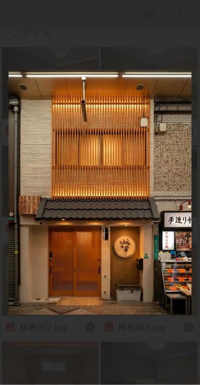 a building with a clock on the front of it at Sumiyoshi Guesthouse 梦阁 粉浜の宿 in Osaka