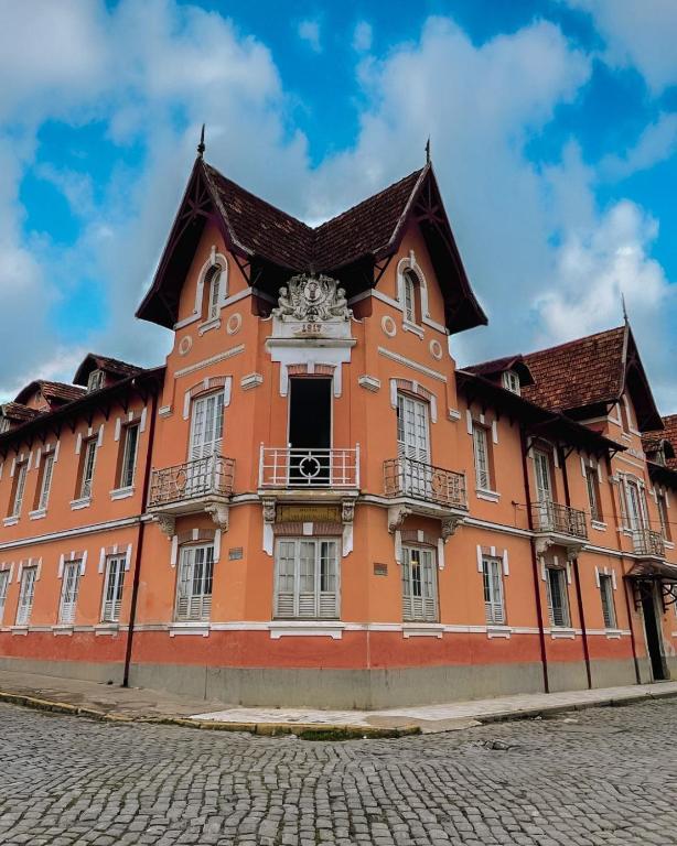 a large orange building with a brown roof at Hotel Valenciano in Valença