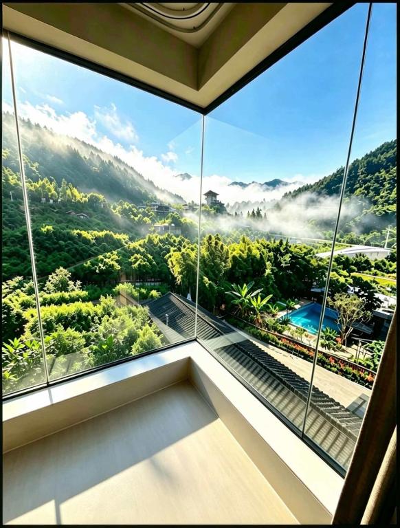 a room with a large window with a view at NAIYI Forest Park Resort in Zhangjiajie