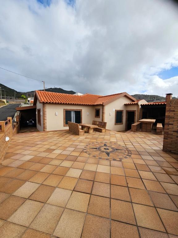 a building with a patio with benches on it at Villa Dourada in Porto Santo