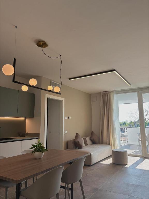 a kitchen and living room with a table and a couch at ALandGIO Smart Stay in Cavallino-Treporti