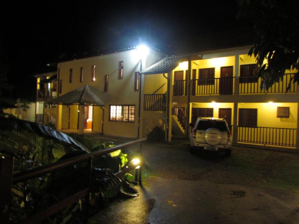 a car parked in front of a building at night at Pousada 3 Bacias Penedo in Penedo
