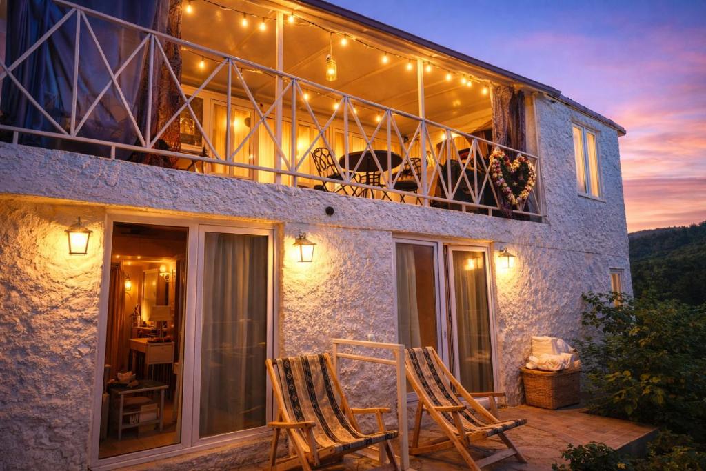 a couple of chairs sitting on a balcony of a house at Sighnaghi Art Hotel in Sighnaghi