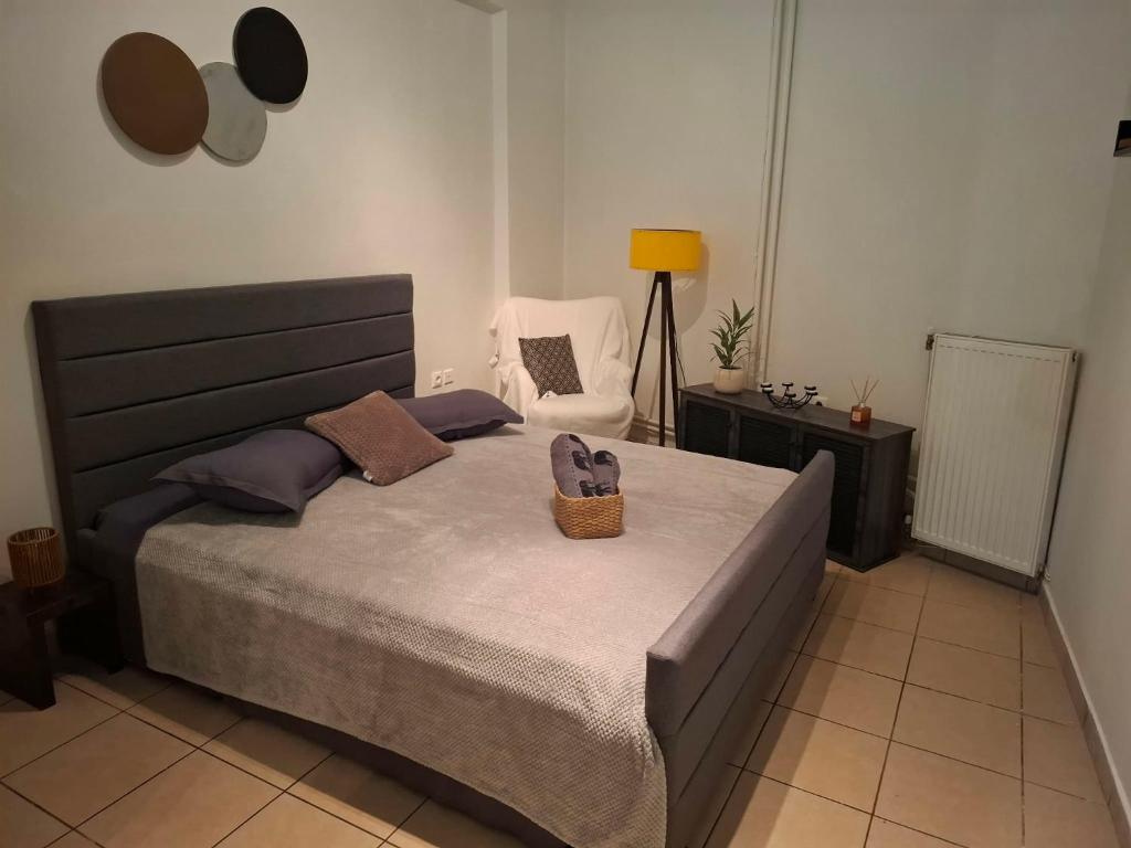 a bedroom with a bed with a basket on it at Le Rocher 3 in Ermoupoli