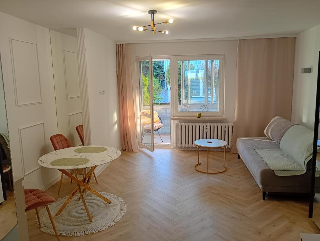 a living room with a couch and a table at Apartament Niebieskie in Zamość