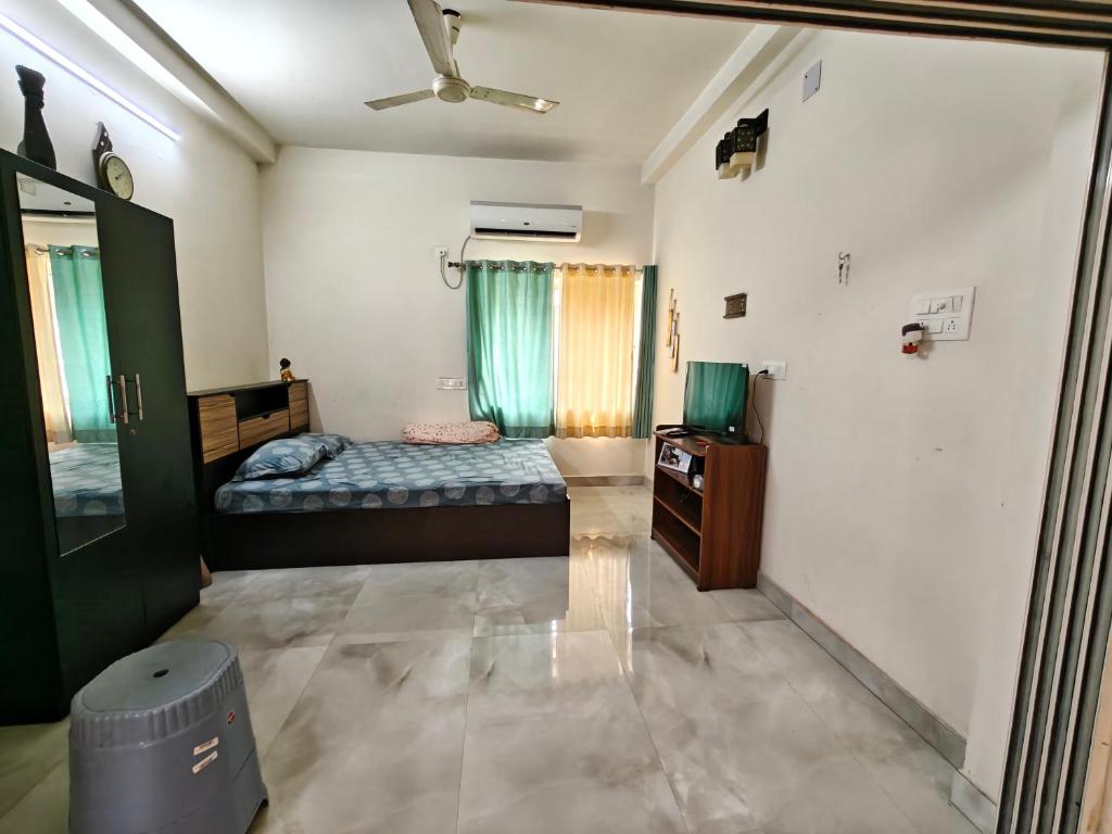 a bedroom with a bed and a tv and a ceiling at Perfect for Homely Atmosphere in kolkata