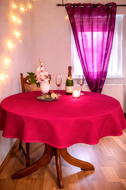 a table with a red table cloth and wine glasses at Holiday Rhein 1 in Boppard