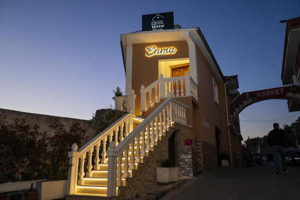 a sanchez sign on the side of a building with stairs at Enma Rooms in Krujë