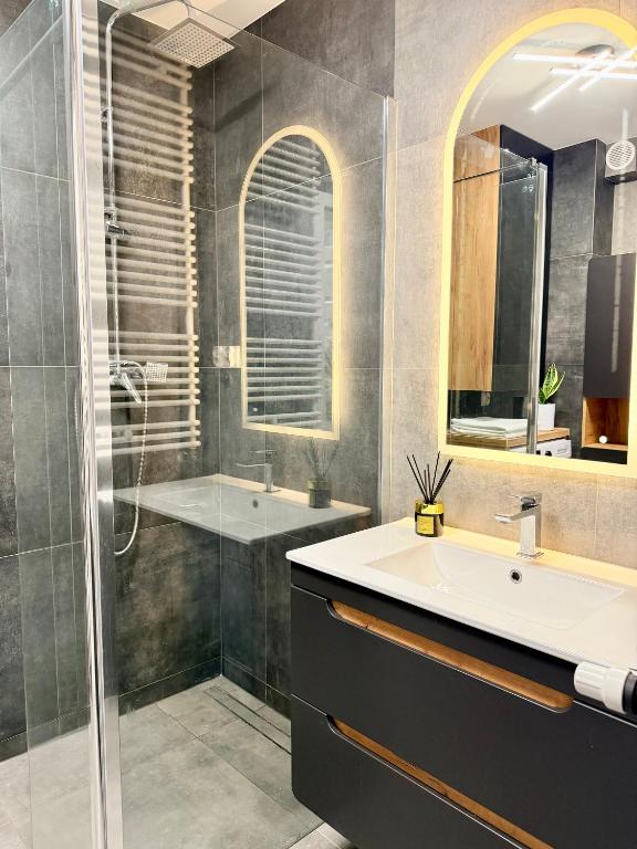 a bathroom with a sink and a shower at Apartament KJ Tomice in Tomice