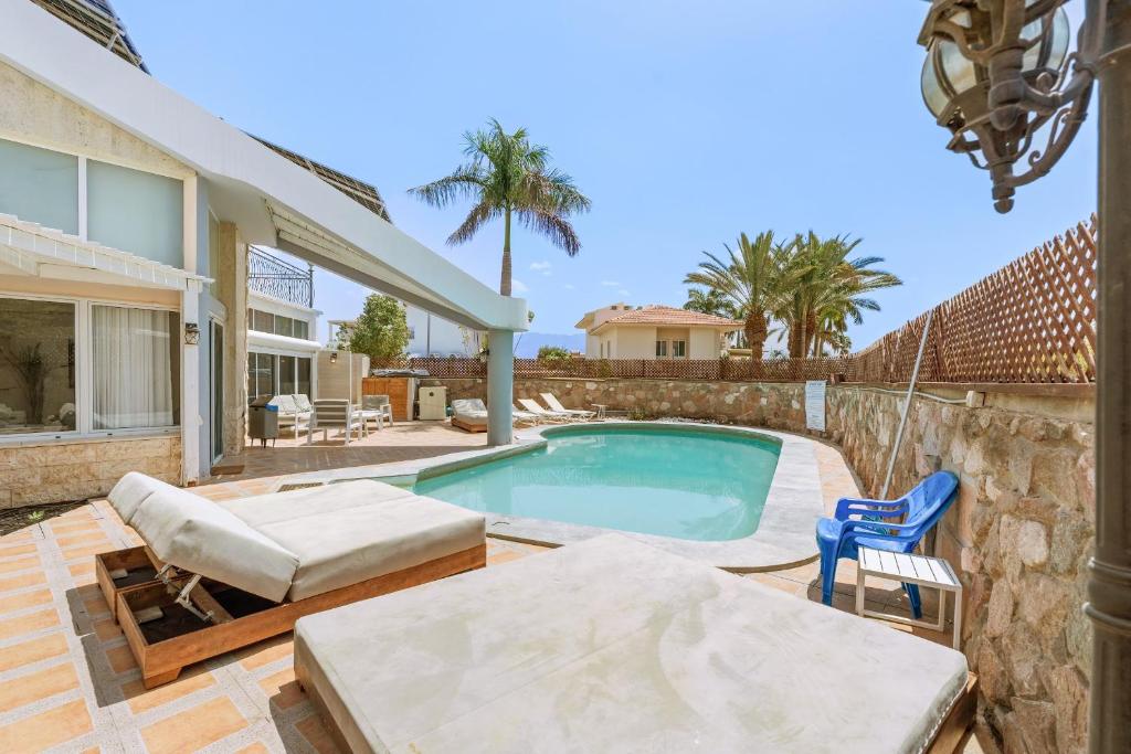 a swimming pool in the backyard of a house at Villa Yuka- Luxurious Villa in Eilat
