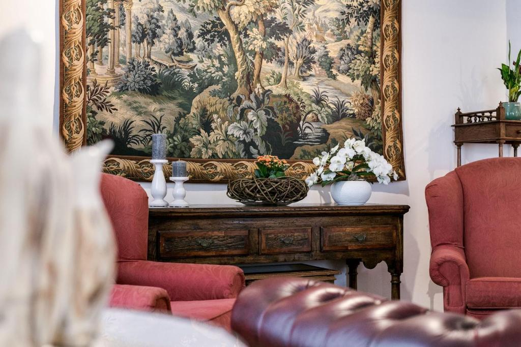 a tapestry hanging on a wall in a living room at Hotel Bryghia in Bruges