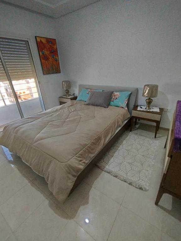 a bedroom with a large bed in a room at hedia a monastir in Monastir