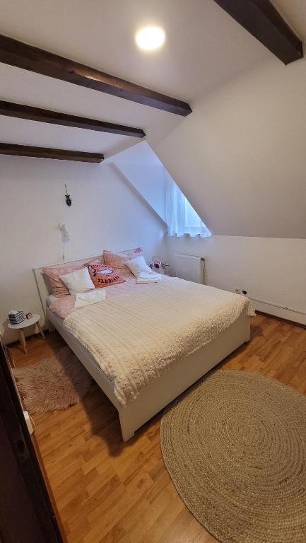 a bedroom with a large bed in a attic at Harcsa Vendégház Tiszafüred in Tiszafüred