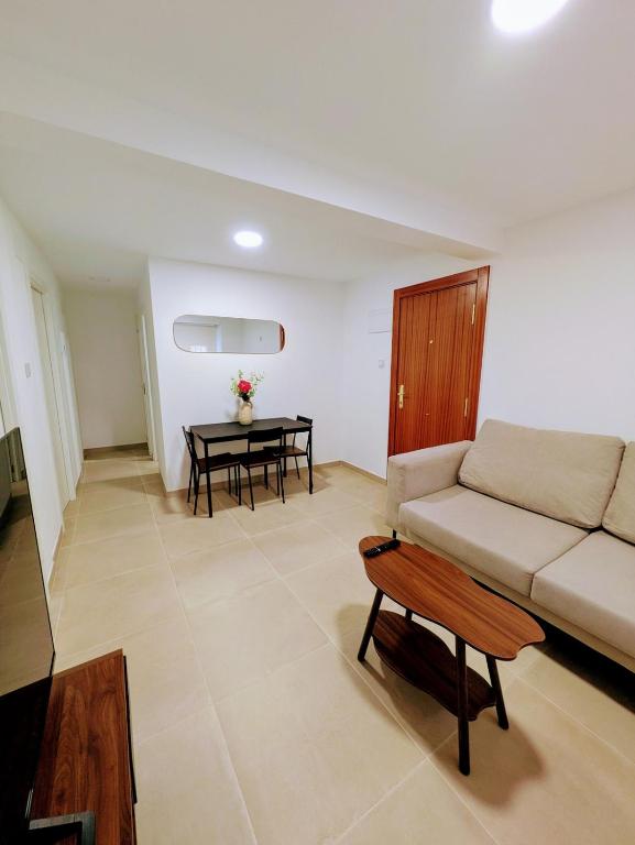a living room with a couch and a table at PisoCentro in Santander