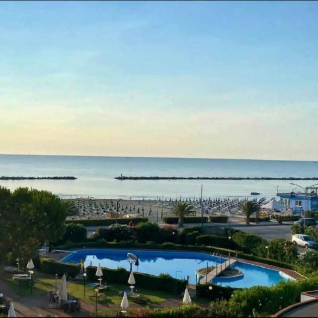 a view of a resort with two pools and the ocean at Casa Vacanze 228 in Villa Rosa