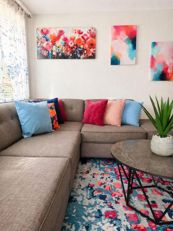 a living room with a couch and a table at NEW Beach Cozy Bungalow 2B Mins-beach&downtown in Clearwater