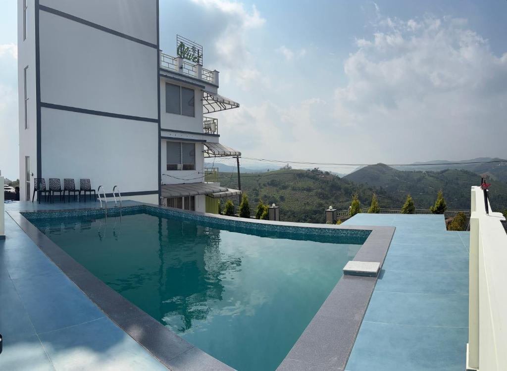 a swimming pool on the side of a building at Olivet Homestay in Vagamon