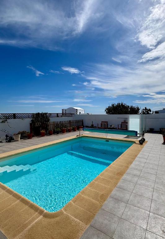a large swimming pool on top of a building at Casita Blum in La Asomada