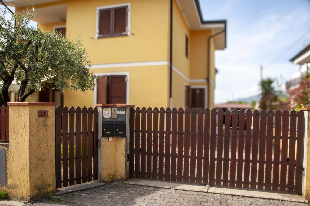 a fence with a parking meter in front of a house at Three Tails House in Capezzano Pianore,