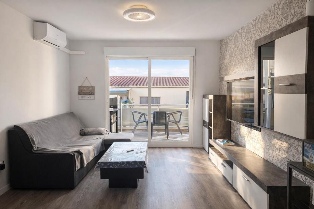 a living room with a couch and a table at TAJ house center altea #B in Altea
