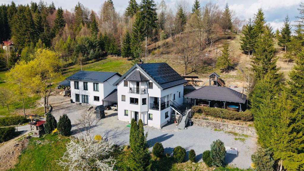 an aerial view of a large white house at Cabana Transylwonder in Sicasău