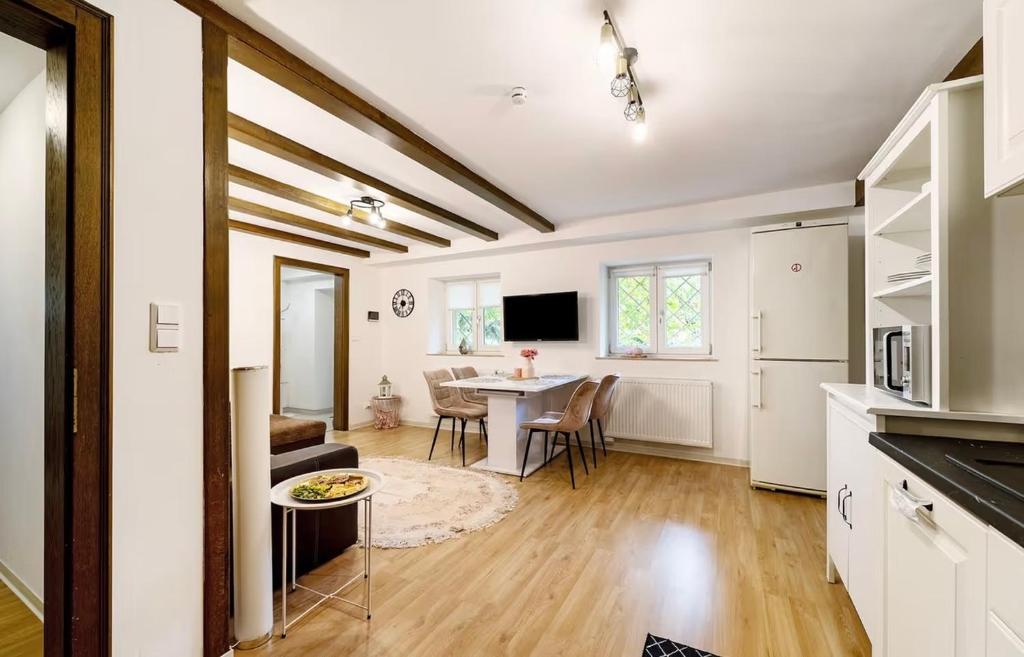 a kitchen and living room with a table and a dining room at Green House in Neunkirchen