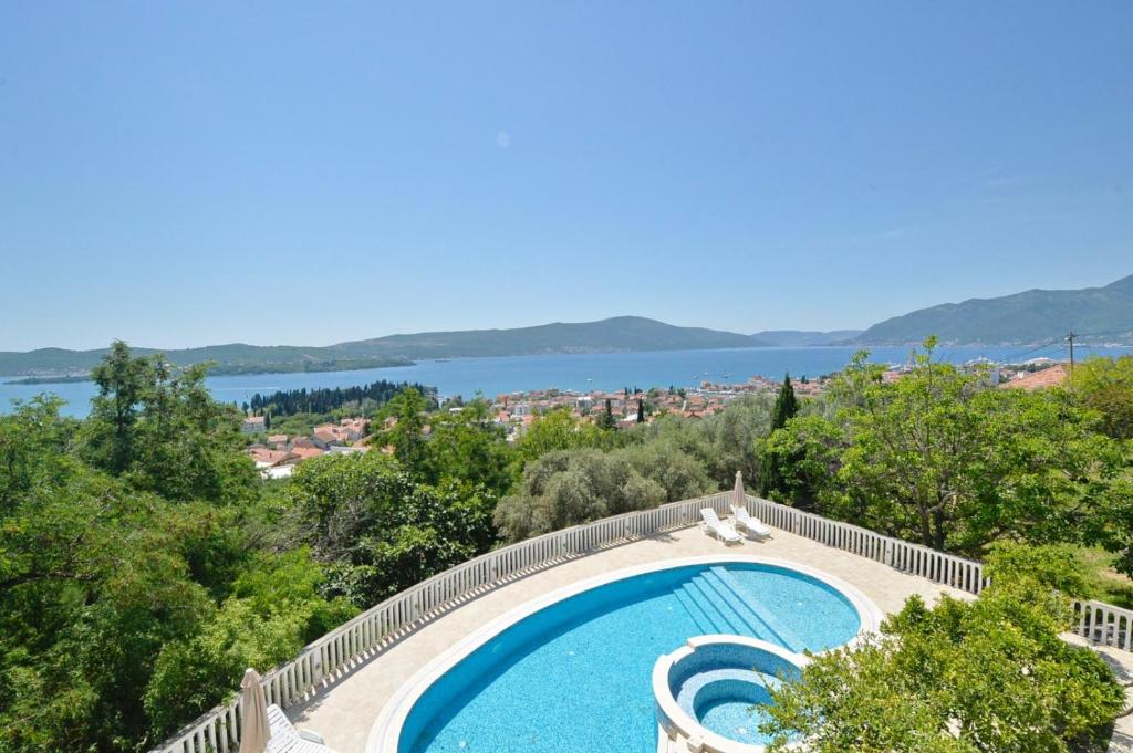 a swimming pool with a view of the water at Zotina Residence in Tivat