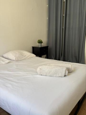 a white bed with two towels on top of it at Cornas in Tournon-sur-Rhône