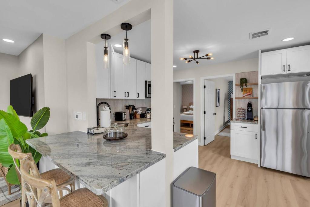 a kitchen with white cabinets and a marble counter top at Prof Cleaned | Linen+Towel | Pet Friendly | Coffee in Seaside Heights