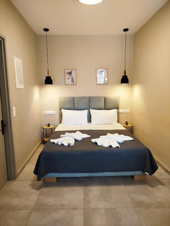 a bedroom with a bed with two towels on it at SeaEsta Vasiliki 1 in Póndi