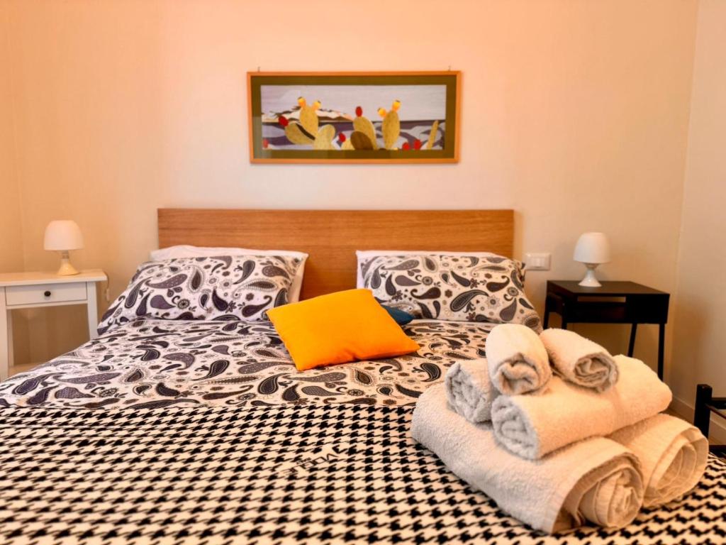 a bedroom with a bed with towels on it at Respiro Mediterraneo in Mondello