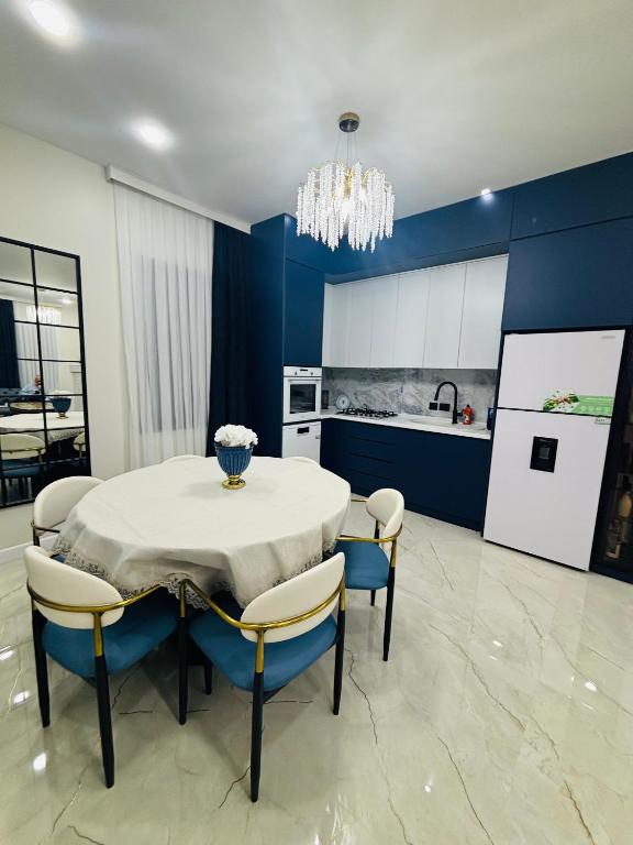 a dining room with a table and chairs and a kitchen at Green Villa in Kobuleti