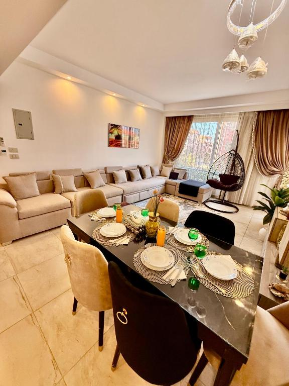a living room with a table and a couch at Oyster bey Beach Suites J1-04 in Marsa Alam