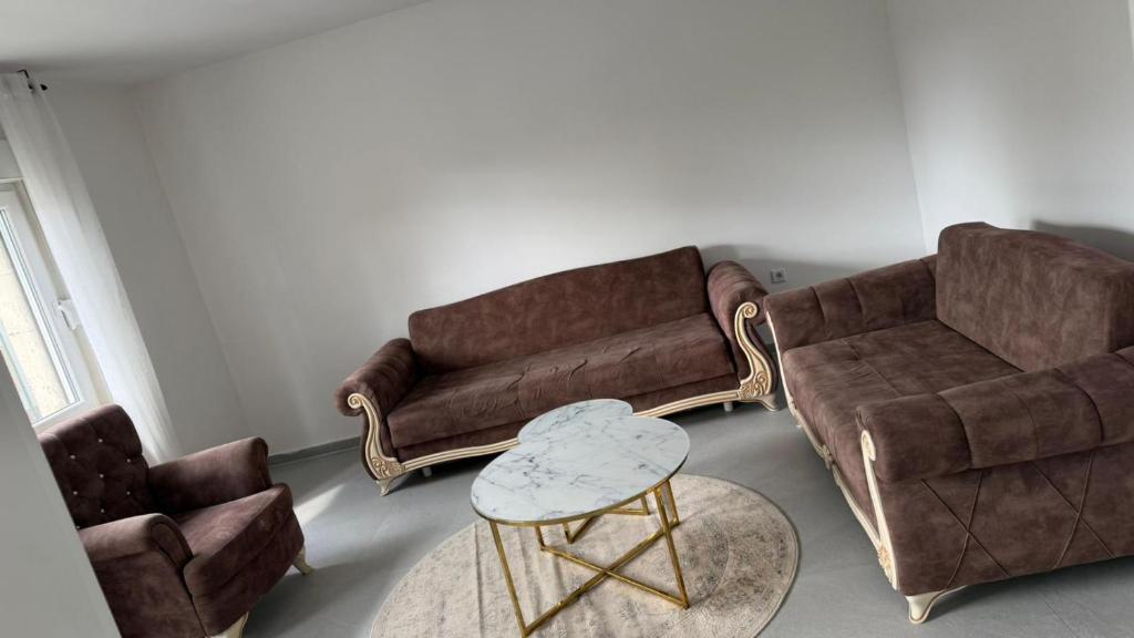 a living room with a couch and two chairs at WorkHome A2 zu 6 in Lünen