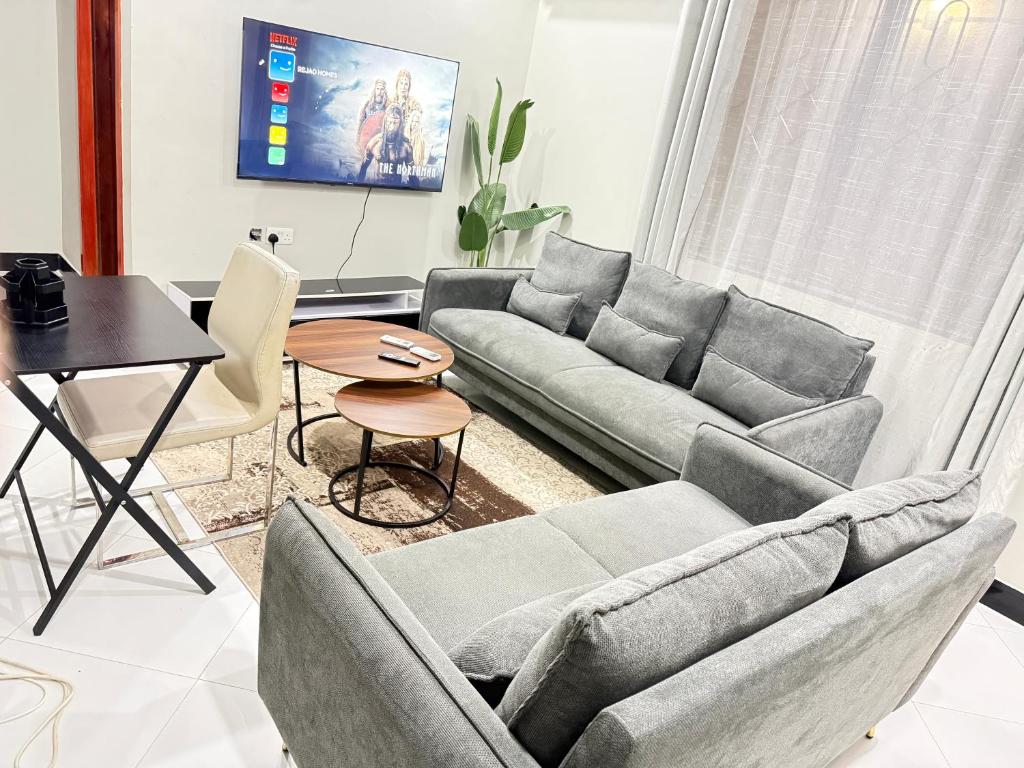 a living room with a couch and a table at Rejao Homes in Dar es Salaam