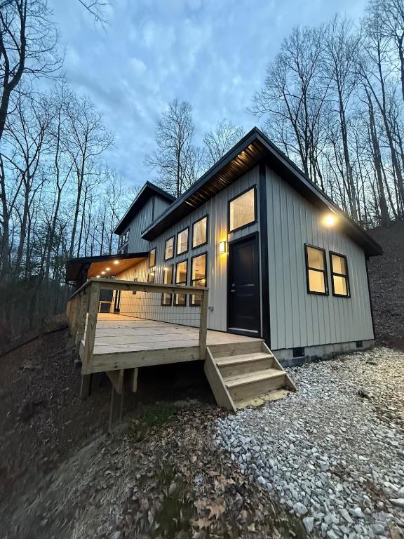a tiny house with a large porch and a deck at Doc Hollywood in Stanton