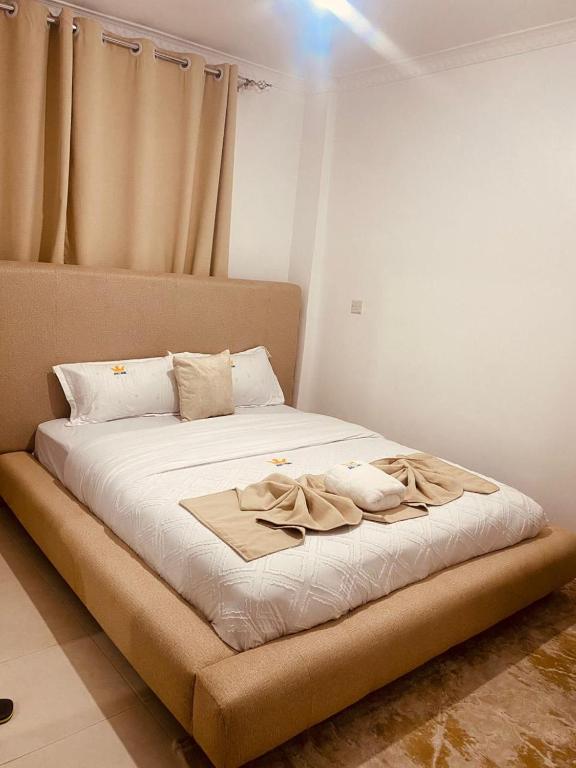 a bed with a blanket on it in a room at Grace Homes in Naivasha