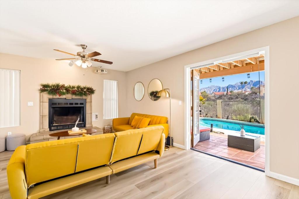 a living room with a yellow couch and a table at The AZ Escape in Tucson