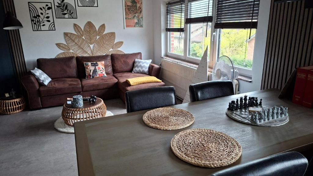 a living room with a table and a couch at "En Aqualye" Appartement 2 personnes chez l'habitant in Aywaille