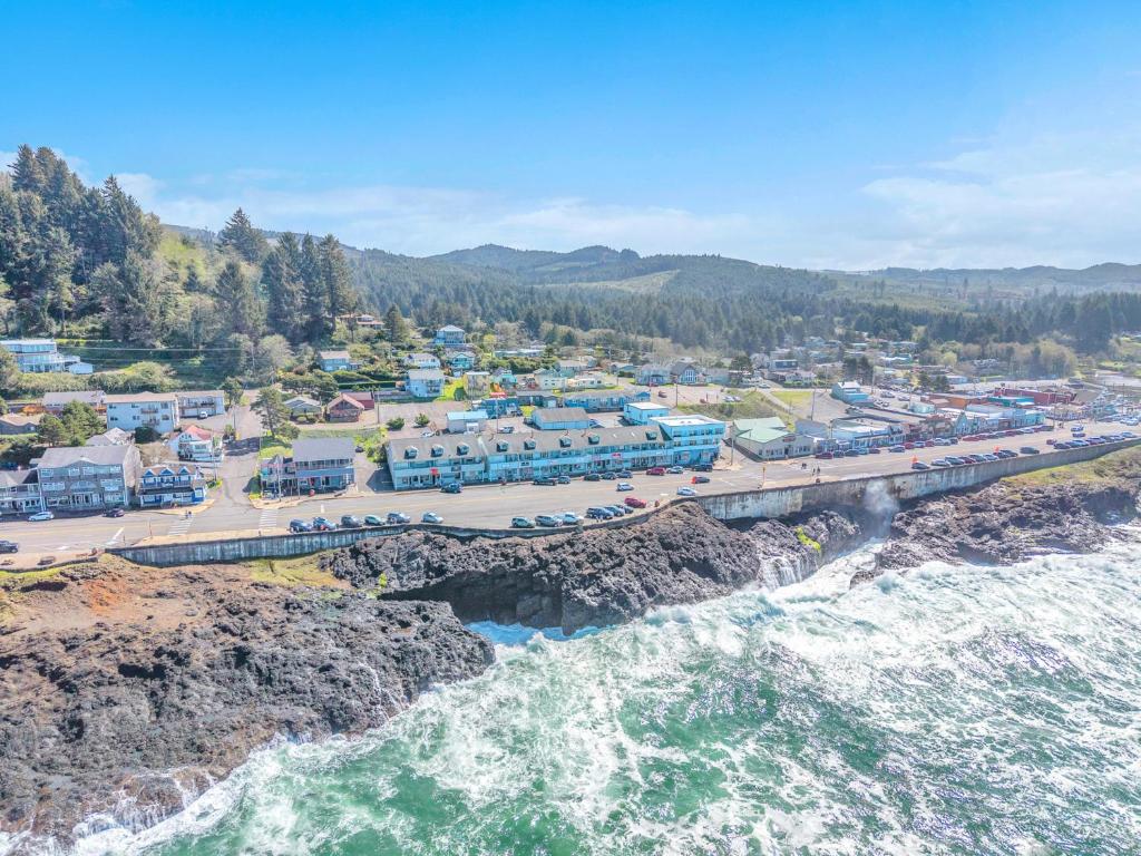 an aerial view of a town with a bridge over the water at Bay Echo in Depoe Bay