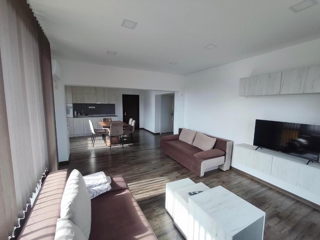 a living room with a couch and a tv at Уютът на Ясен in Yasen